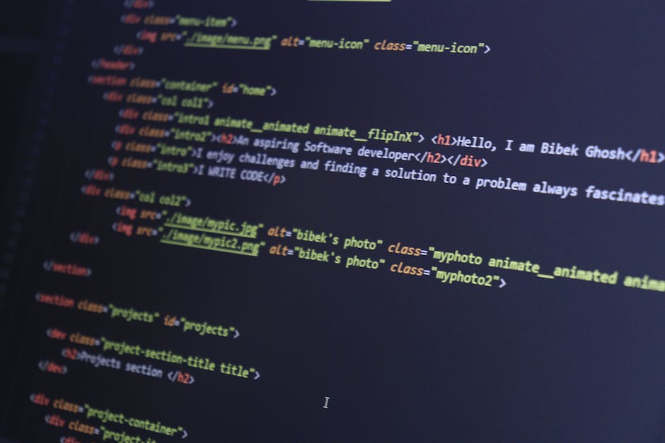 Close-up image of a computer screen displaying lines of colorful code, including functions, variables, and syntax highlighting. The screen shows a development environment with a dark background and mu